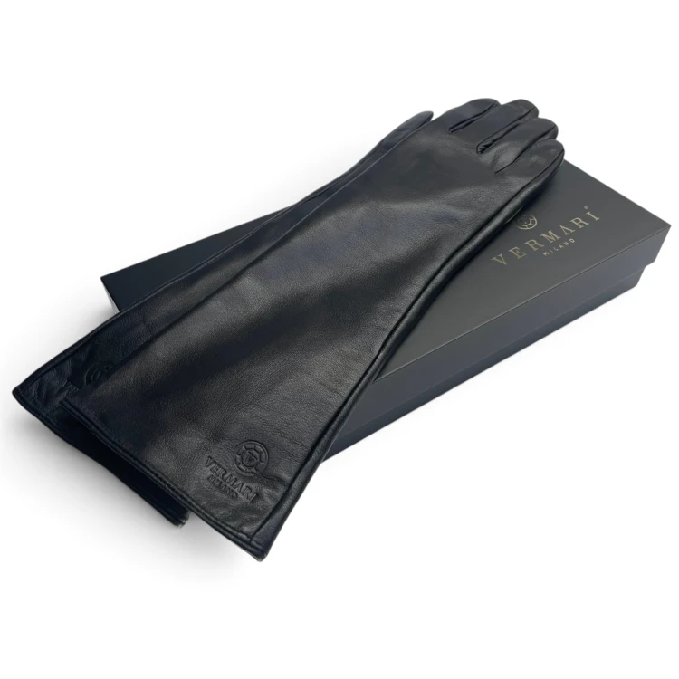 Vermari Milano VWGL-100L - long black leather gloves laid diagonally on a black box, embossed logo near the lower cuff edge