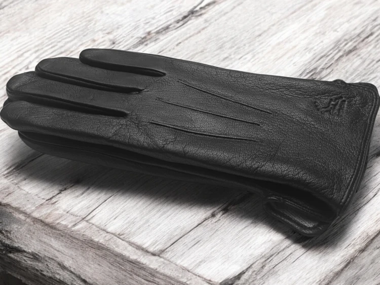 Men's leather gloves PRIUS LUX PRMG-2006 - laid one on the other on light wood with the embossed deer